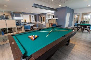Game room with gaming tables, billiards, and shuffleboard